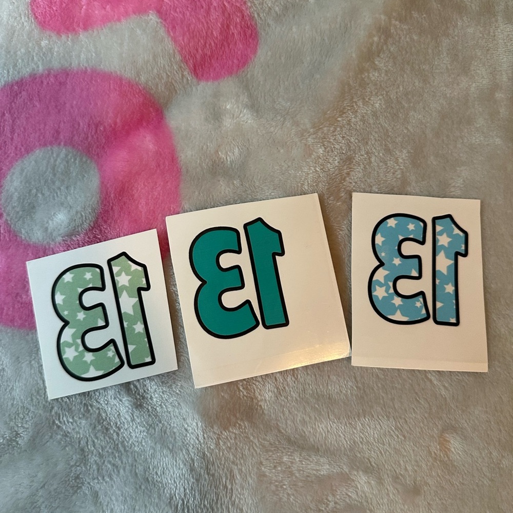 Three Taylor Swift #13 green, turquoise, and blue star temporary tattoos